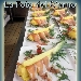 Barchetta d'ananas con petali di speck del Trentino, colata di miele di acacia e gherigli di noci tostati - -