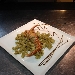 Riccioli di pasta all' uovo aromatizzata al basilico di Pr� con sugo all'aragosta e pistacchio di Bronte - -