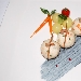 Perle di nasello al latte con verdurine campagnole saltate all'olio con crema al nero di seppia - -