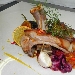 Maialino confit all'arancio e olio toscano, fichi caramellati e lamelle di peperoncino (e la sua demi glac�) - Fotografia di Francesco Suria - -