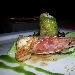 Roll� di branzino con gamberi rossi e pistacchi in foglia di lattughina su vellutata di patate al limone e capperetti di Pantelleria con bavarese di melanzane - -