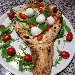 La racchetta (con manico ripieno di ricotta di bufala campana e provola di Agerola, con rucola selvatica, dattarino rosso, bocconcini di bufala e olio extravergine d'oliva) - -