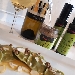medaglioni di spinaci ripieni di ricotta e spinaci lessi casarecci  su salsa di cereali, pat� di olive e mandorle - -