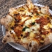 Le due Sicilie (Parmigiana di melanzane (pomodoro, mozzarella, melanzane fritte, olio) con cornicione a stella ripieno di ricotta) - -