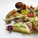 Raviolo di pasta cotta ripieno di ricotta e limone, salsa di zucchine, vongole, gambero rosso e briciole di pane - -